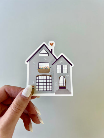 House sticker being held