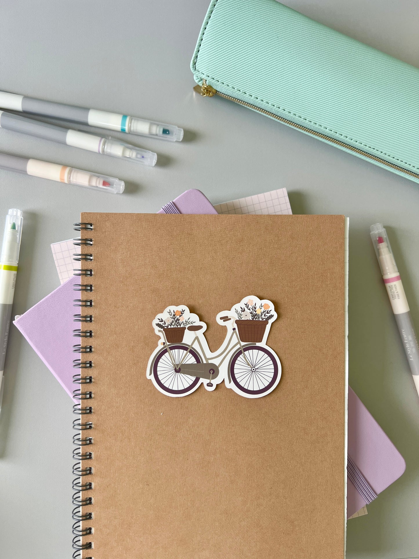 Green bike sticker being used with other stationery products