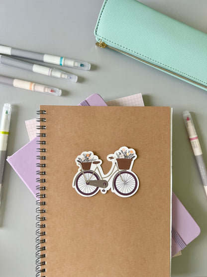 Green bike sticker being used with other stationery products