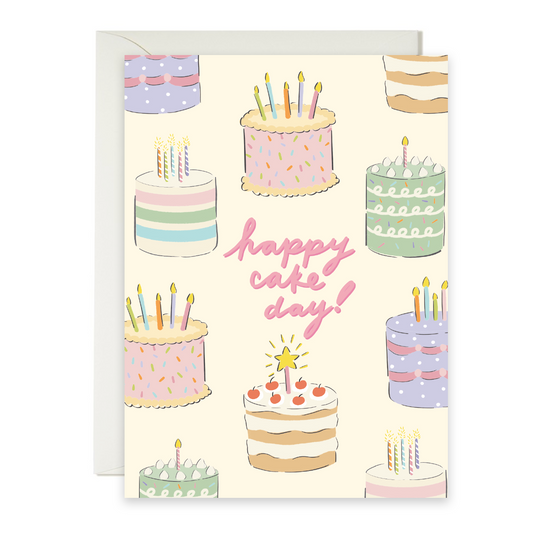 Greeting card with illustrations of cakes and 'happy cake day!' text on a white background
