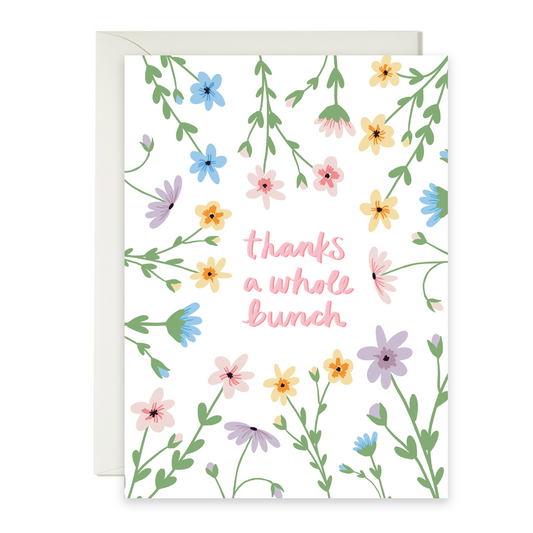 Greeting card with abundant flowers with 'thanks a whole bunch' text on a white background